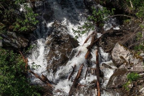 A waterfall cascades down a steep rock face, Roståa stream, near Sel, Gudbrandsdalen, Norway