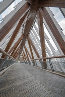 Interior view of a modern wooden bridge with glass roof