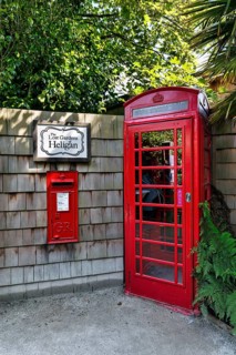 Traditional red telephone box, letterbox, sign with inscription, Lost Gardens of Heligan, Cornwall,