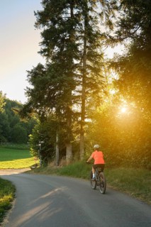Active senior woman rides her electric mountain bike in Westallgäu near Lindenberg, Bavaria,