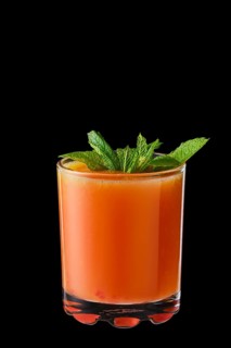 Hot red currant and orange winter drink with honey isolated on black