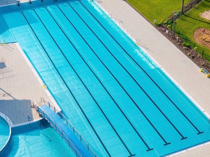 Large outdoor pool with marked swimming lanes and light blue water surface, Calw Stammheim outdoor