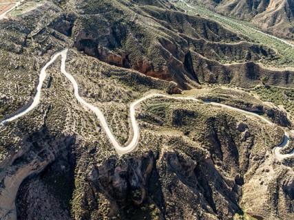 Canyons and gorges near village Gorafe, winding road, aerial view, Gorafe Desert, UNESCO Granada