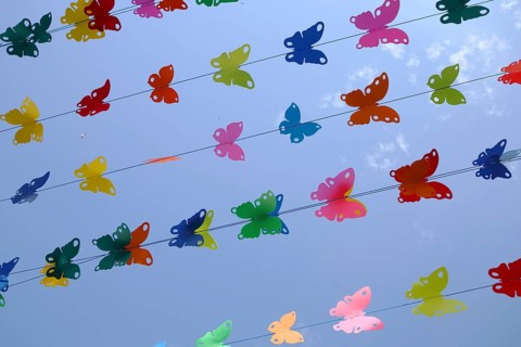 Butterfly figures as colourful decoration on ropes, pennant chain, parallel, detail, row, series,