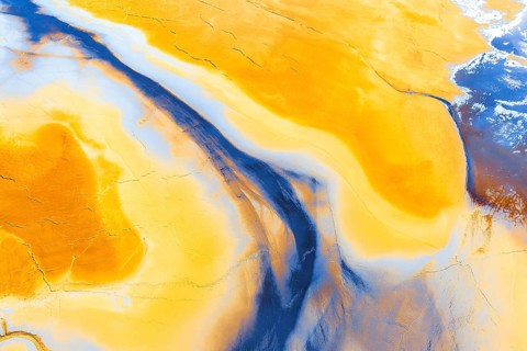 Stunning aerial photograph capturing a surreal abstract landscape with swirling patterns of rich