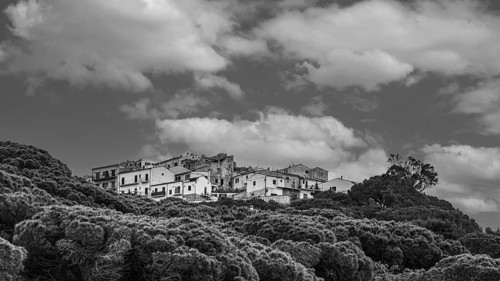 The village of Capoliveri, view from the beach della Madonna, black and white photograph, Elba