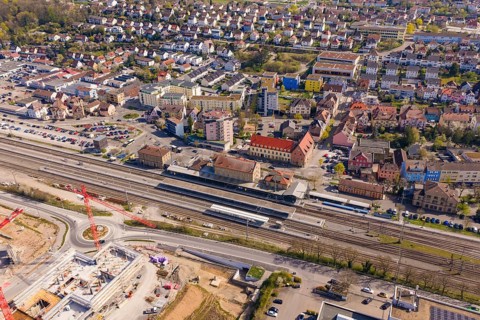 Urban area with train stations and residential areas, surrounded by traffic routes, PV plant at Obi