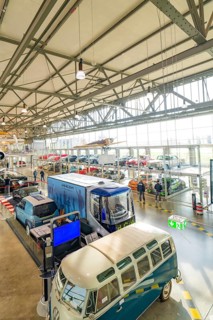 Large room with vintage and modern cars, industrial architecture, Motorworld Böblingen, Germany