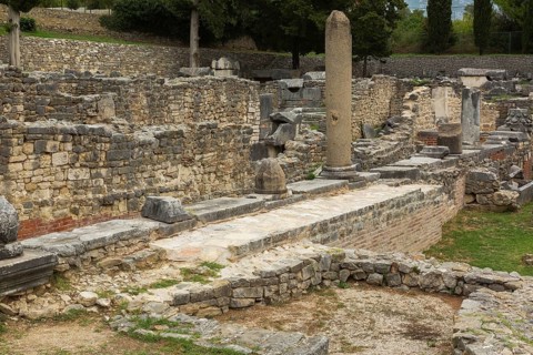 Old grey stone and red brick wall structures and columns at ancient 3rd century Roman ruins of