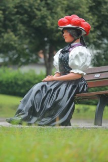 Doll in woman's traditional costume with Bollenhut on bench, Black Forest, Bollenhut, clothing,