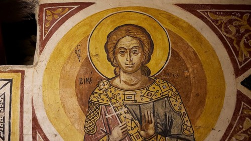 Depiction of a holy figure with book and halo on church wall, Thari Monastery, Moni Thari, near