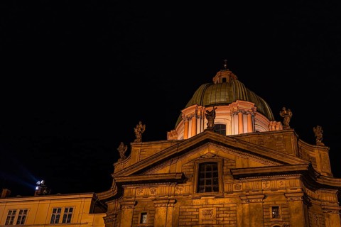 A beautifully lit historical building in Prague, showcasing intricate architectural details and