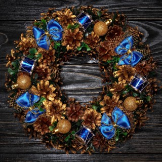 Christmas wreath on dark wooden background