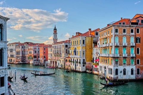 VENICE, ITALY, JUNE 27, 2018: Grand Canal with boats and gondolas on sunset, Venice, Italy
