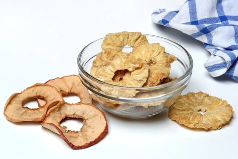 Dried pineapple slices in peel and dried apple rings, dried fruit