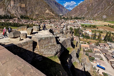 Historic stone platform overlooking a city and surrounding mountains, The Inca ruins of