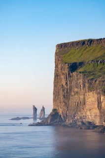 The Risin og Kellingin pinnacles off the Eysturoy cliffs in the evening light, Faroe Islands,