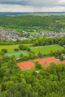 Tennis and soccer fields in the midst of a rural, wooded village landscape, Aidlingen sports field,