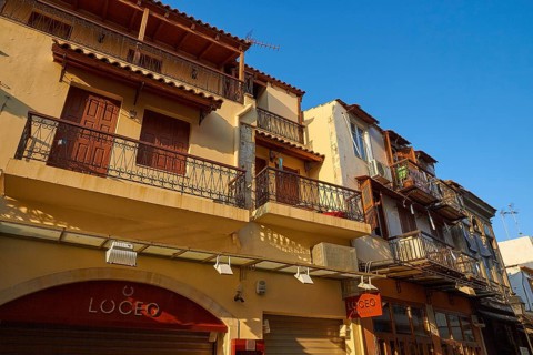 Venetian old town, morning light, wide angle shot, balconies, colourful row of houses, blue