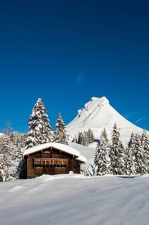 Snow-covered mountains and mountain hut with ski slope, Damülser Mittagspitze, Damüls,