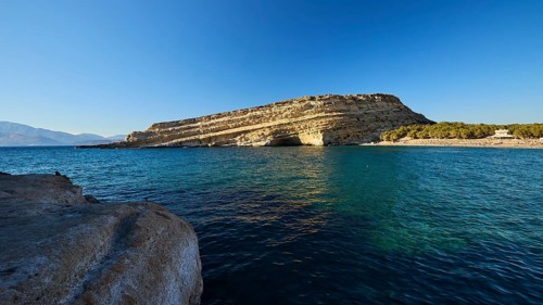 Neolithic caves, former hippie paradise, rocky landscape by the sea under clear blue sky with calm