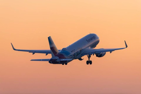 Passenger aircraft after take-off, in front of sunrise, Eurowings, Baden-Württemberg, Germany