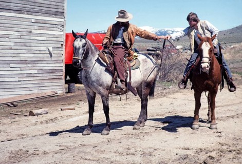 Nevada City historic ghost town, Montana, USA two cowboys on horses