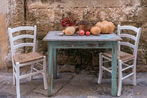 Decoration with table, chairs and autumn vegetables in an alley, Gallipoli, Apulia