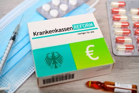 PHOTO MONTAGE, pill box with the inscription health insurance reform +++ editorial use only