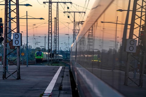 Flixtrain train arriving at Essen central station, reflected in an ICE train, dusk, North