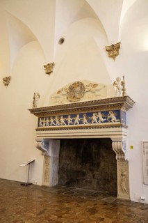 Fireplace with mantelpiece with angel figures in Palazzo Ducale, Unesco world heritage site Urbino,