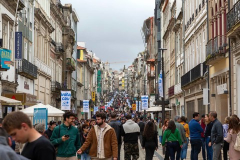 People in crowded main shopping street, Rua de Santa Catarina, city of Porto, Portugal