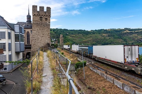 Freight train, in the Upper Middle Rhine Valley, runs directly in front of the residential