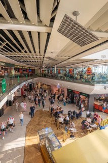 Busy airport terminal with shops and bright lights, lots of travelers moving, Airport, Dublin,