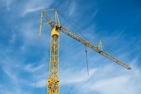 Construction crane against blue sky with white clouds, Soest, Westphalia, North Rhine-Westphalia,