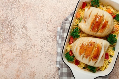Stuffed squid carcasses, baked in the oven, fried, with couscous, top view, homemade, no people