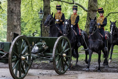 Mounted gunners of the King's Troop Royal Horse Artillery escort a gun carriage and limber across