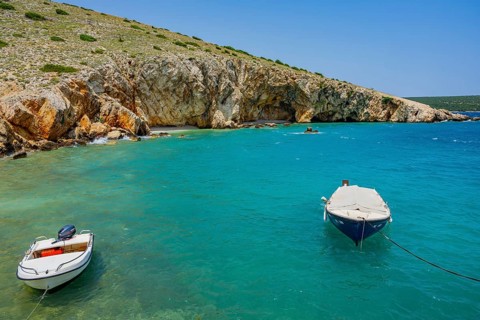 Boats lying on the sea in Koromacna Bay on a sunny day on the island of Cres, Croatia