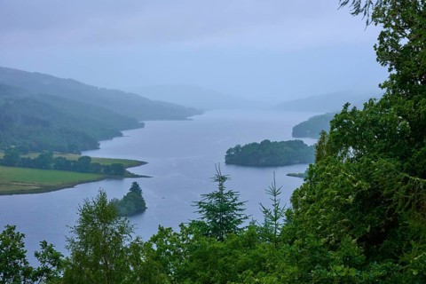 A tranquil lake surrounded by green trees and misty hills, Queens View, Fincastle, Pitlochry,