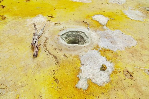 Splashes of sulphur colouring Stefanos crater ground, Nisyros Island, Dodecanese Islands, Greece