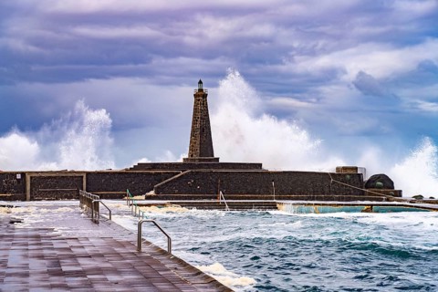 Surf at the seawater swimming pool and the Faro de Bajamar lighthouse, Bajamar, San Cristóbal de La