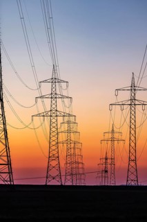High-voltage pylons, overhead power lines at sunset. Schwieberdingen, Baden-Württemberg, Germany