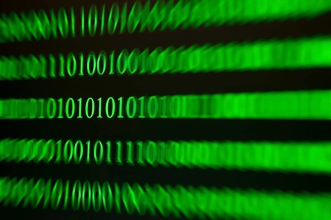 A blurred green binary code as a sign of movement and speed