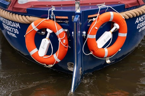 Lifebuoys with signal buoys, on a canal boat in Amsterdam Netherlands