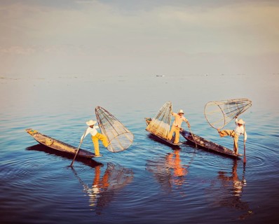 Myanmar travel attraction, Traditional Burmese fishermen balancing with their fishing net on boats