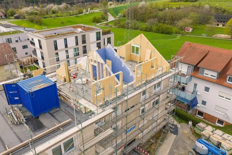 Construction site with a partially constructed building, wooden scaffolding and a construction