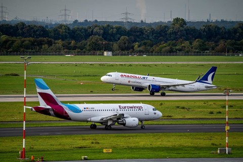 Düsseldorf Airport, Anadolujet aircraft on take-off, Eurowings Airbus on the taxiway for take-off