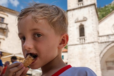 Young boy eating ice cream during summer day
