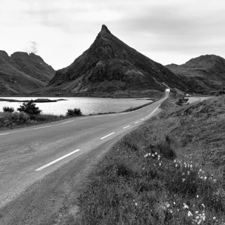 Pyramid-shaped mountain Volandstinden, Volandstind, Fredvang bridges, monochrome, coastal landscape