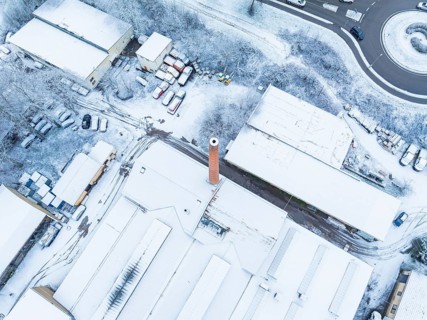 Industrial complex with high chimney, covered with snow, taken from the air, Nagold, Black Forest,